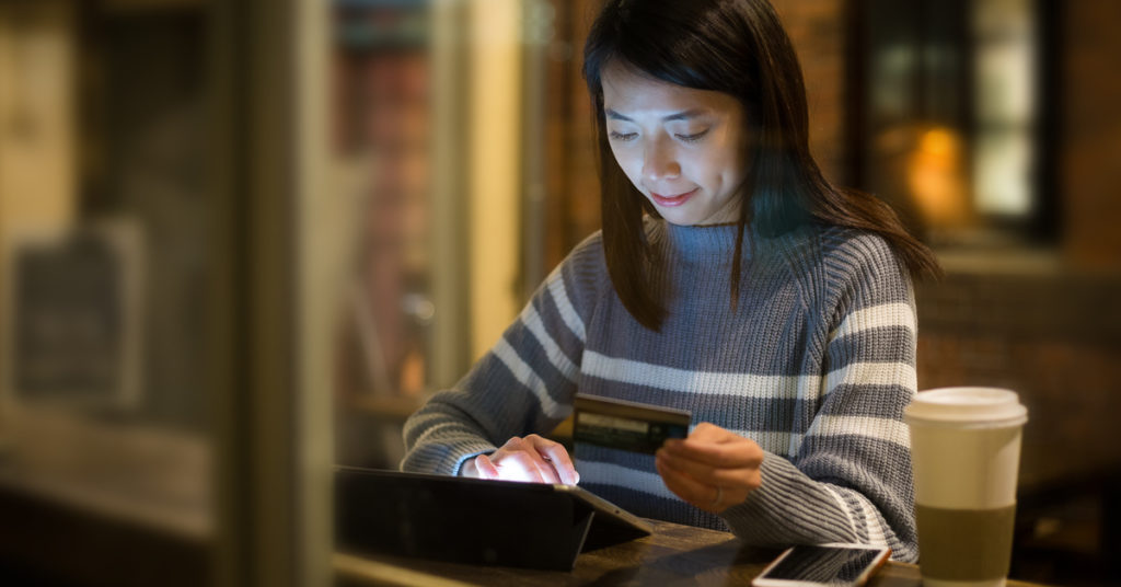 A women entering her card details in tablet